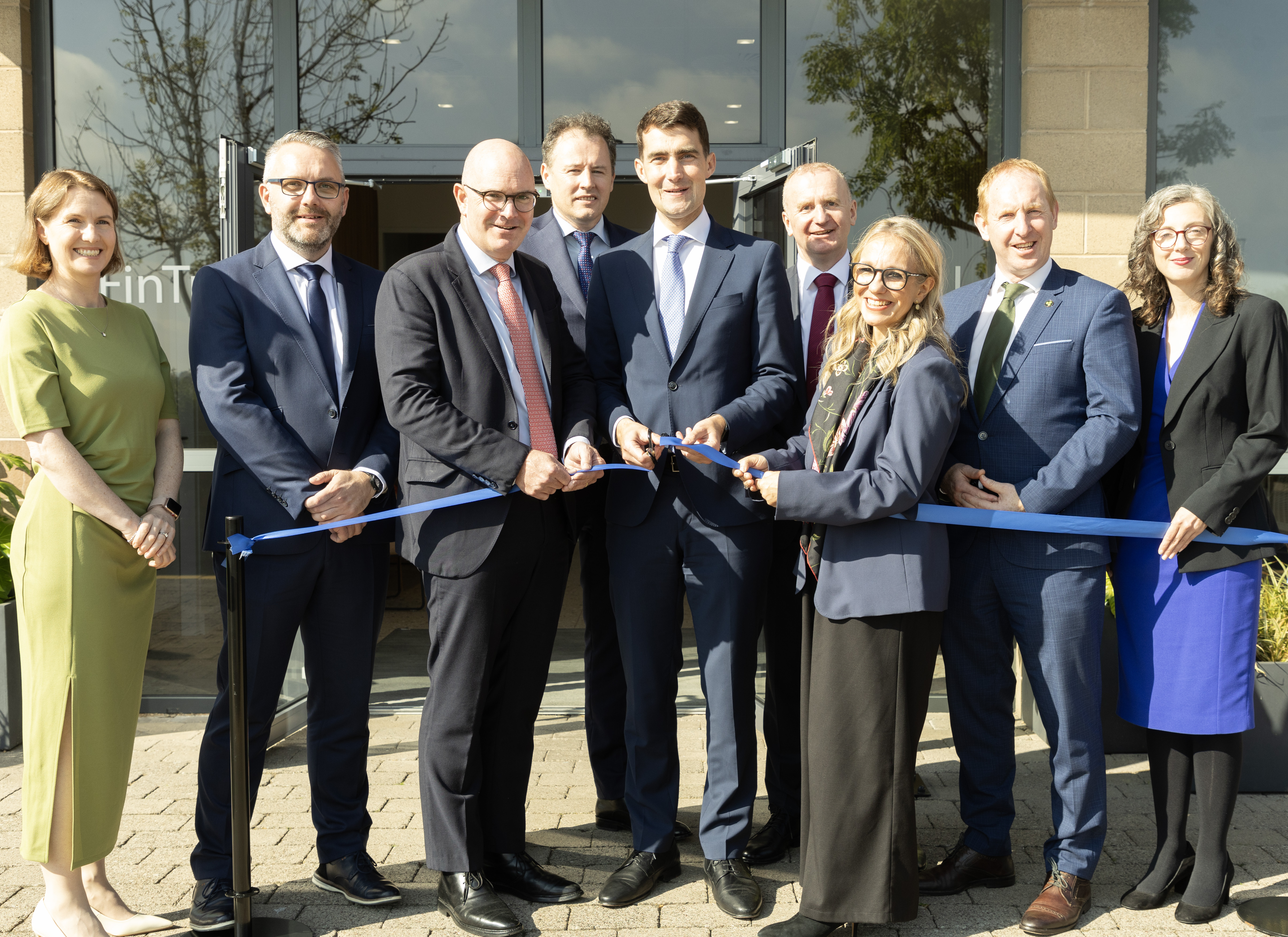 FinTrU staff in front of the new Letterkenny office cutting a blue ribbon for the office opening
